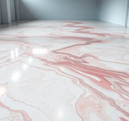 Professional installer applying epoxy resin floor with a durable, glossy finish in a commercial