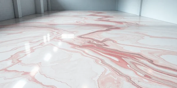 Professional installer applying epoxy resin floor with a durable, glossy finish in a commercial